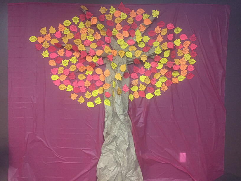 Caliente Construction's Tree of Gratitude with colorful hand-written notes as leaves.